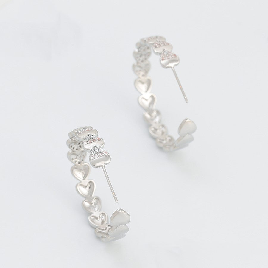 Boucles d'oreilles créoles coeurs rhodiés